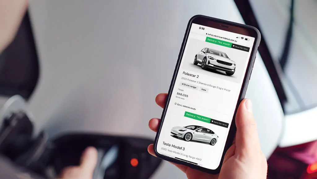 Hand holding a phone displaying evHub's electric car listings, including Polestar 2.